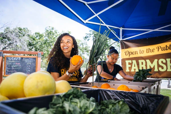 Girl eating orange at a fair